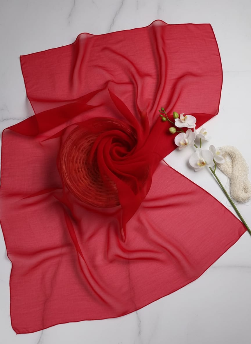A vision in vibrant red, this fabric balances structured volume with sheer beauty.