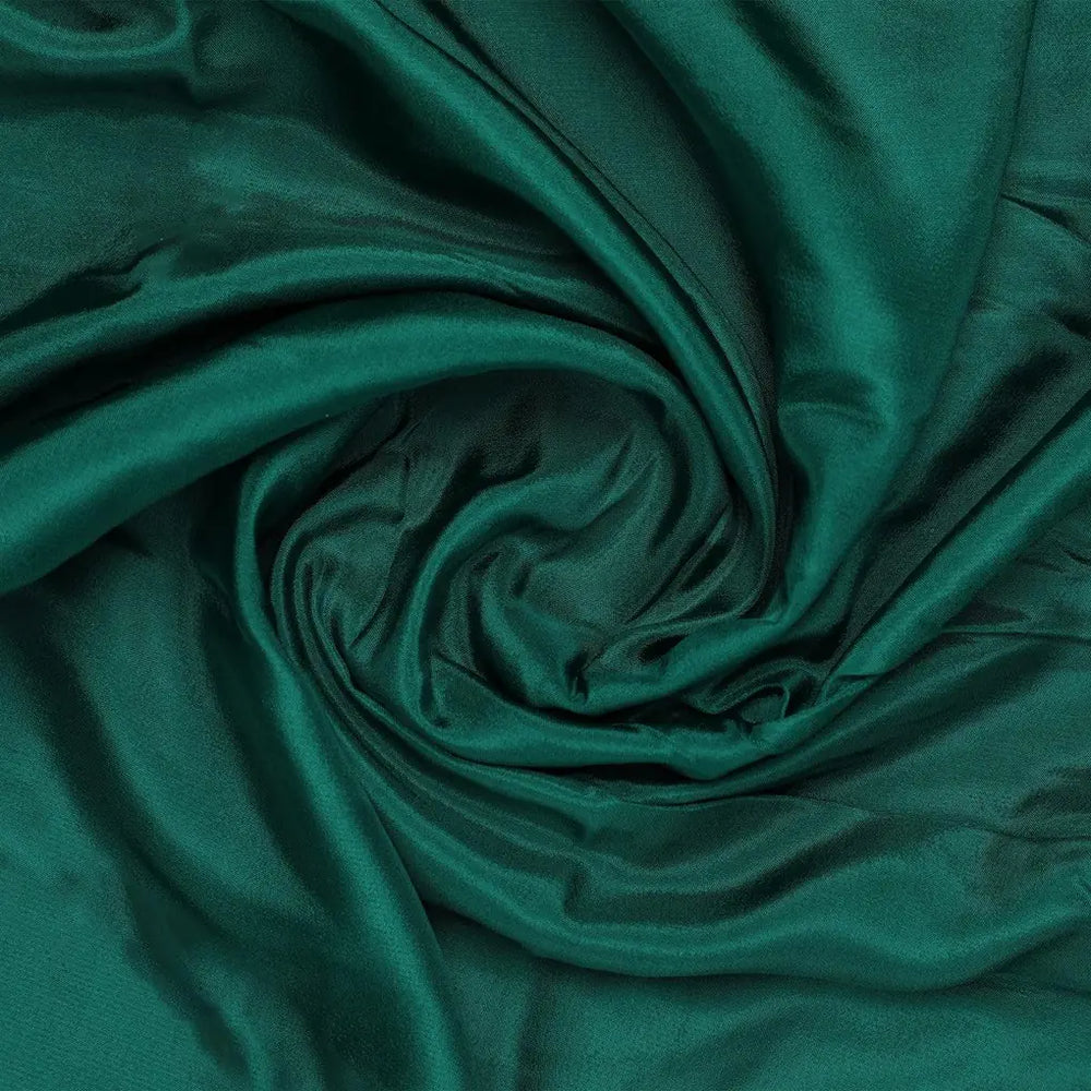 This fabric captivates with its deep emerald hue and an exceptionally fluid drape.